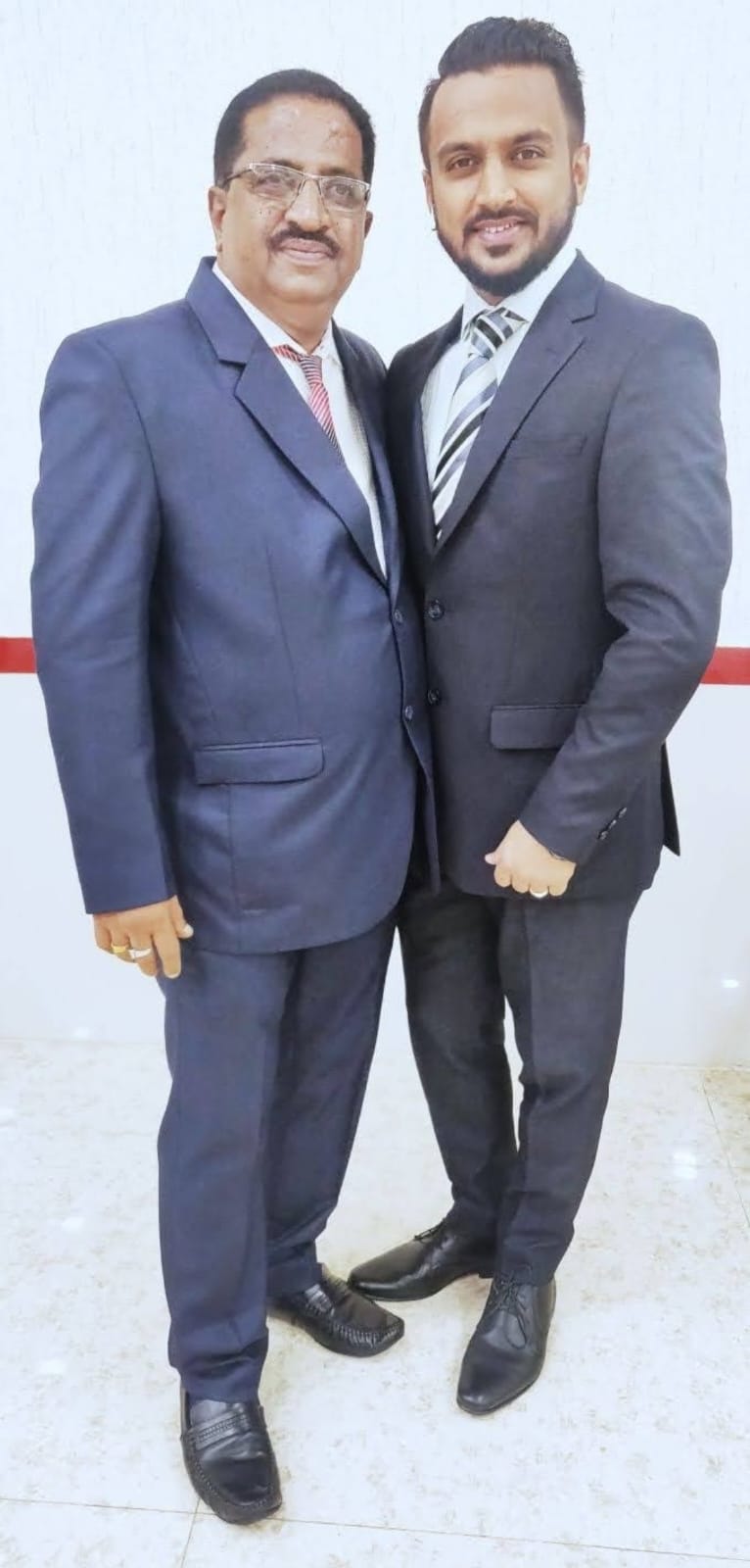 Praful Morjaria and Darshit Morjaria together in formal suits